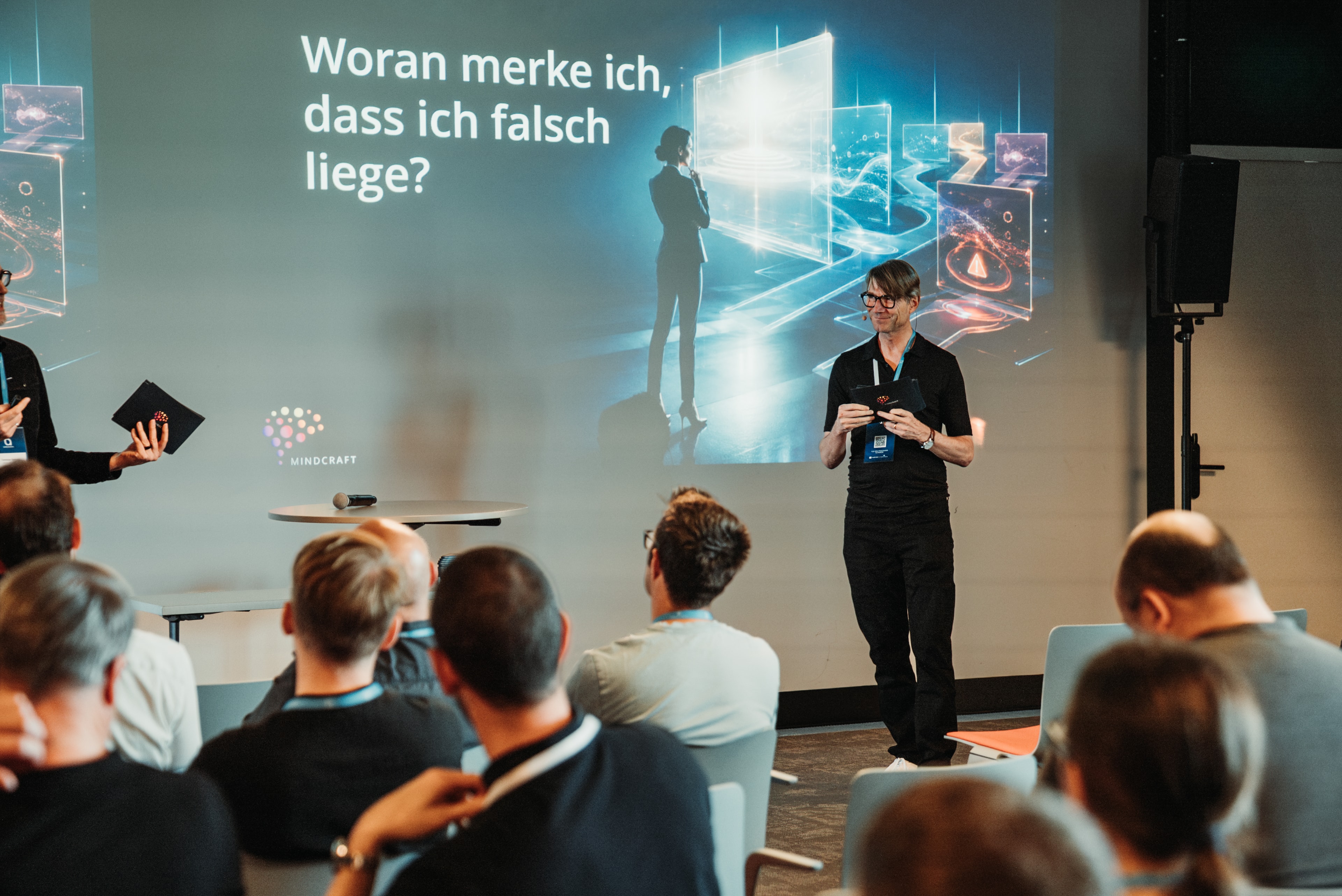 Tomislav and Eric delivering a keynote in front of an audience